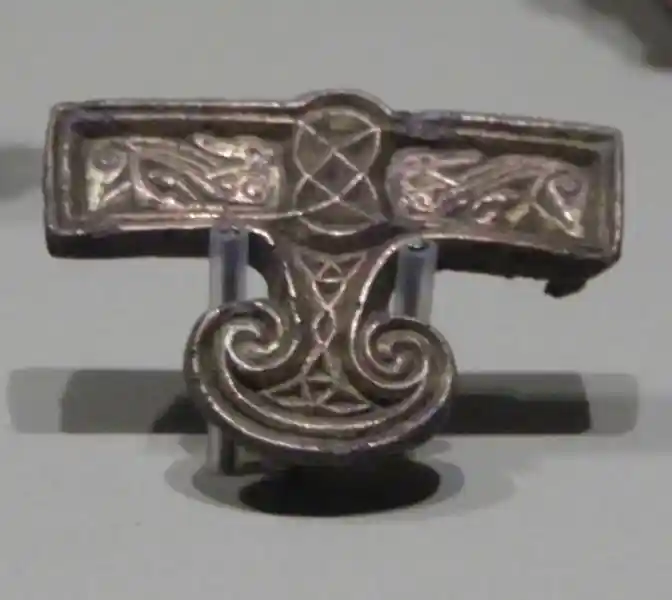 A mount harness in the shape of a winged disc with a phallic design at the center